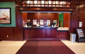 a lobby of a store with a bar in it at Mackinaw Beach and Bay Inn & Suites in Mackinaw City