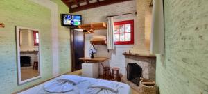 a bedroom with a bed and a fireplace at Alas De La Sierra in Monte Verde