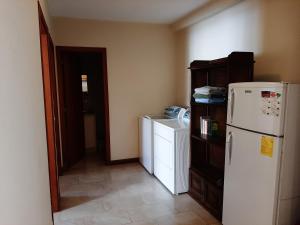 a kitchen with a refrigerator and a washer and dryer at Beautiful Place Apartment in Quito