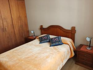 a bedroom with a bed with two pillows on it at Beautiful Place Apartment in Quito