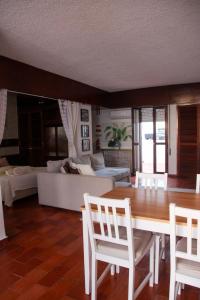 a living room with a table and chairs and a couch at Marina 2 in Vilamoura