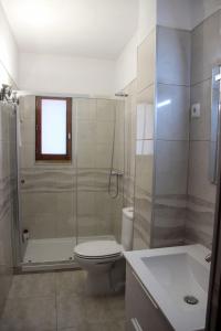 a bathroom with a toilet and a shower and a sink at Marina 2 in Vilamoura