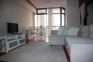 a living room with a couch and a television at Marina 2 in Vilamoura +6 photos