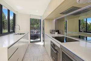 a kitchen with a sink and a large window at Breeze Mooloolaba, Ascend Hotel Collection in Mooloolaba