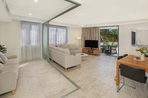 a living room filled with furniture and a large window at Breeze Mooloolaba, Ascend Hotel Collection in Mooloolaba
