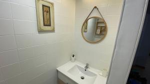a white bathroom with a sink and a mirror at Apartamento Sweet Home Vitoria in Vitoria-Gasteiz +18 photos