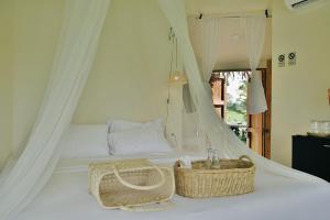 a bedroom with a bed with a basket on it at Doowall Hotel in Chiang Rai