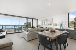 a living room with a table and a couch at Lorne Chalet Apartment 38 in Lorne