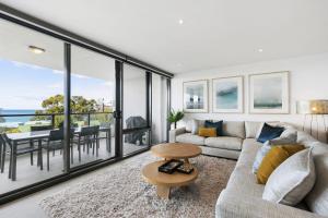 a living room with a couch and a table at Lorne Chalet Apartment 38 in Lorne