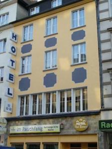 a yellow building with blue paint on it at Hotel Drei Kronen in Dortmund