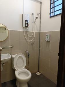 a bathroom with a shower and a toilet and a sink at Reco Villa Private Pool 4 Bedrooms@ Taman Mayung Teluk Kemang Port Dickson in Port Dickson
