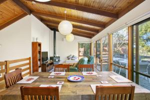 a dining room with a wooden table and chairs at Apollo Bay People N Paws in Apollo Bay