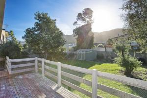 a white fence in front of a yard at Apollo Bay People N Paws in Apollo Bay