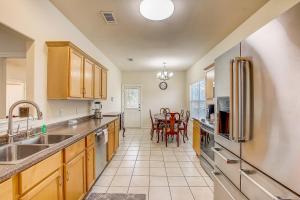a large kitchen with wooden cabinets and a table at Granite Getaway in Granite Shoals