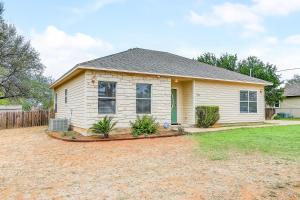 a small white house with a yard at Granite Getaway in Granite Shoals