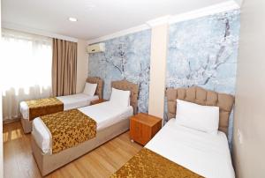 a hotel room with two beds and a mural at Seyri Istanbul Hotel in Istanbul +96 photos