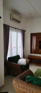a living room with a couch and a window at Villa Azalea in Cireungit