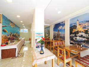 a restaurant with tables and paintings on the walls at Seyri Istanbul Hotel in Istanbul