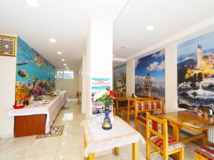 a restaurant with tables and paintings on the walls at Seyri Istanbul Hotel in Istanbul