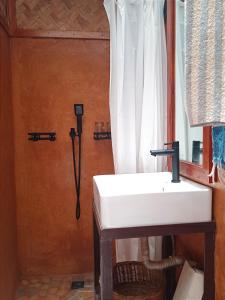 a bathroom with a white sink and a window at At Home annex in Puerto Princesa City