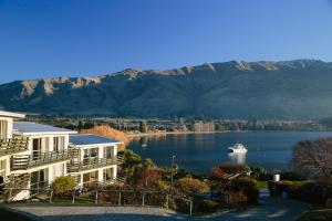 a view of a lake with a boat in the water at Panorama Court in Wanaka