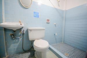 a blue bathroom with a toilet and a sink at Boracay Morning Beach Resort in Boracay +29 photos