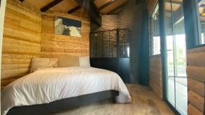 a bedroom with a bed in a wooden wall at L 58 LODGE de LUXE in Lège-Cap-Ferret