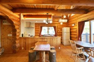 a kitchen and dining room in a log cabin at ログキャビン伊豆高原 in Futo