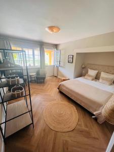 a bedroom with a large bed and a table at Le Mouron Rouge in La Garde-Freinet +118 photos