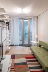 a living room with a couch and a large window at Luxury Apartment Berlin Mitte in Berlin