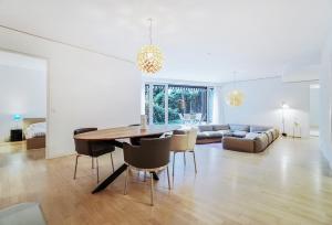 a dining room and living room with a table and chairs at Luxury Apartment Berlin Mitte in Berlin