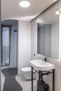 a bathroom with a toilet and a sink and a mirror at Luxury Apartment Berlin Mitte in Berlin