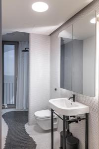 a bathroom with a toilet and a sink and a mirror at Luxury Apartment Berlin Mitte in Berlin +5 photos