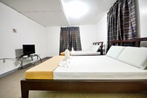a bedroom with a large bed and a tv at Boracay Morning Beach Resort in Boracay