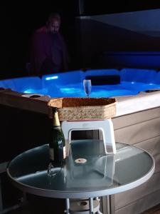 uma garrafa de vinho numa mesa ao lado de um bar em Ticase Colibris em Saint-Leu