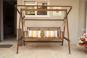 a wooden swing in a room with a window at SantaCara City Apartment in Lefkada