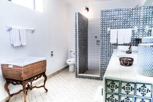 a bathroom with a sink and a toilet and a shower at Casa Galeana- Tropical 1-BD 1-WC Mountain Top Luxury Suite with Stunning Views in Ajijic