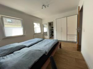 a large bed in a room with a large window at Gästehaus Trulla in Bremm