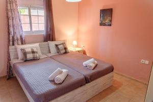 Seashore Apartments في Chorafakia: غرفة نوم عليها سرير وفوط