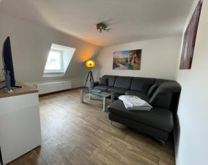 a living room with a couch and a tv at Gästehaus Trulla in Bremm