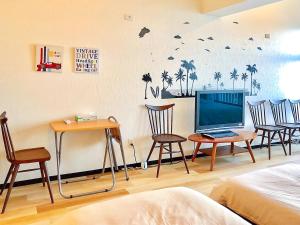 Pokój z krzesłami, telewizorem i łóżkiem w obiekcie Azama Ocean View Terrace w mieście Azama