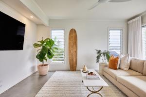 a living room with a couch and a table at Sunsets at Epic Lennox Head in Lennox Head