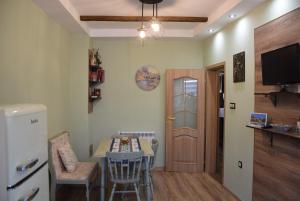 a living room with a table and a refrigerator at Boutique House Belevi in Nesebar