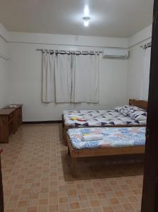 Postel nebo postele na pokoji v ubytování Sanctuary Transient House Bacolod