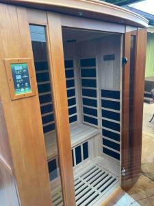 a small sauna with a sign on the door at Tavares house in Waialua
