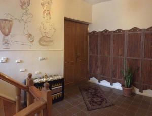 a room with wooden cabinets and a room with a piano at Sweet Home in Yerevan