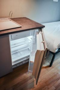 an open refrigerator with a wooden counter top at Botanika Uppsala in Uppsala