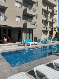 a hotel with a swimming pool in front of a building at Aitch Boutique Hotel - an LIH Hotel in Madaba