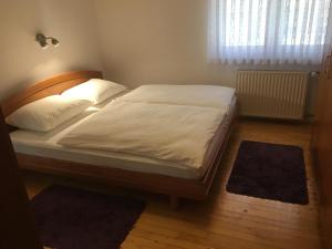 a bed with a wooden headboard in a bedroom at Rooms Hrominc in Bled