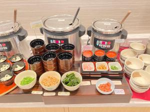 a shelf with several jars and bowls of food at Osaka Riverside Hotel in Osaka